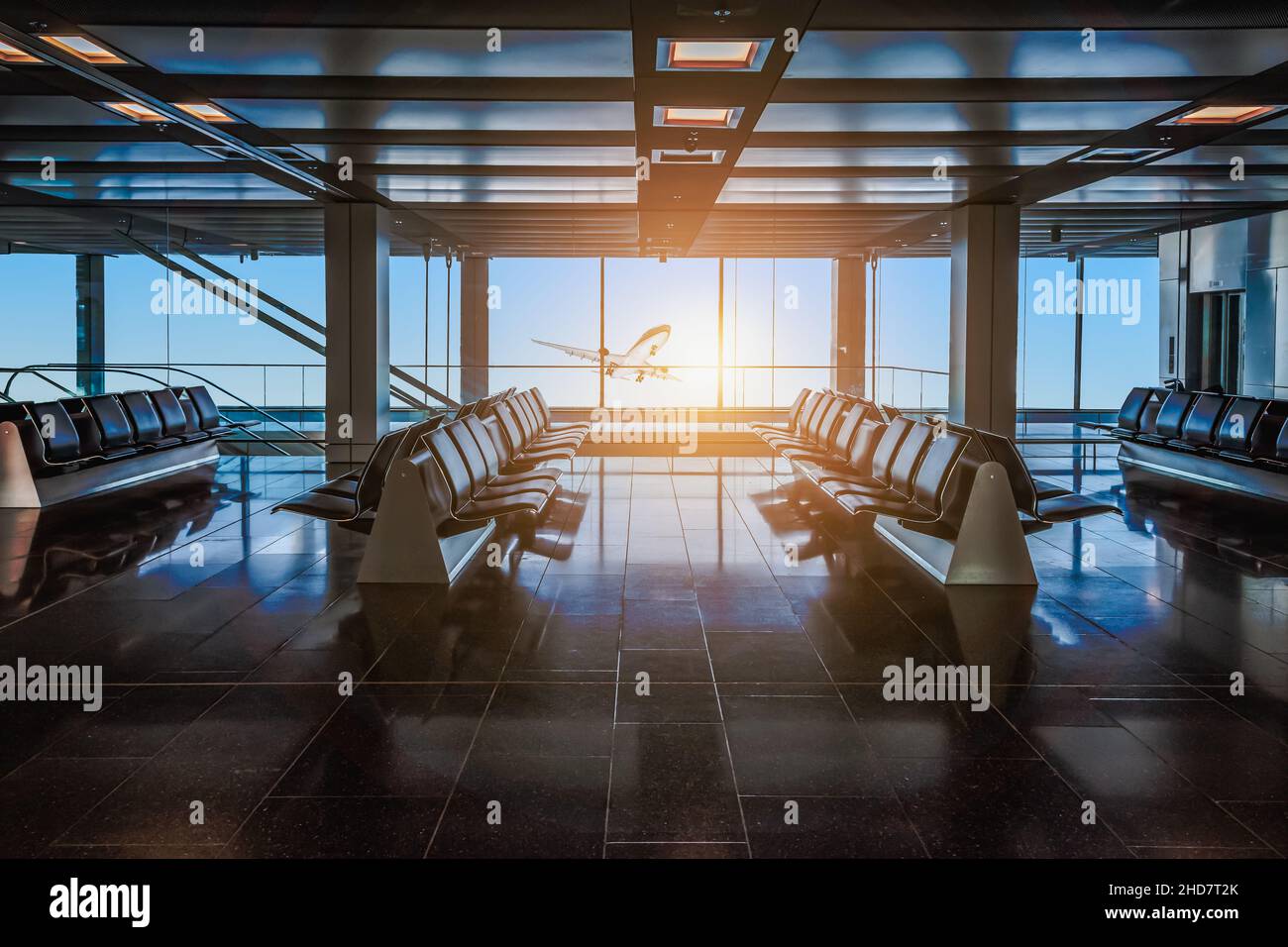 Airport departure hall with empty waiting seats. Stock Photo