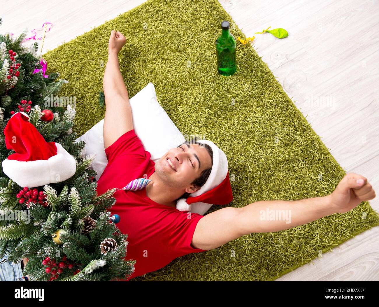 The young man drunk at home after christmas party Stock Photo Alamy