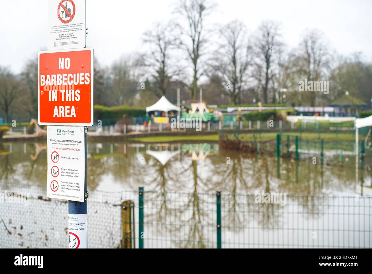 No barbecues in this area sign overlooking a flooded park area. Stock Photo