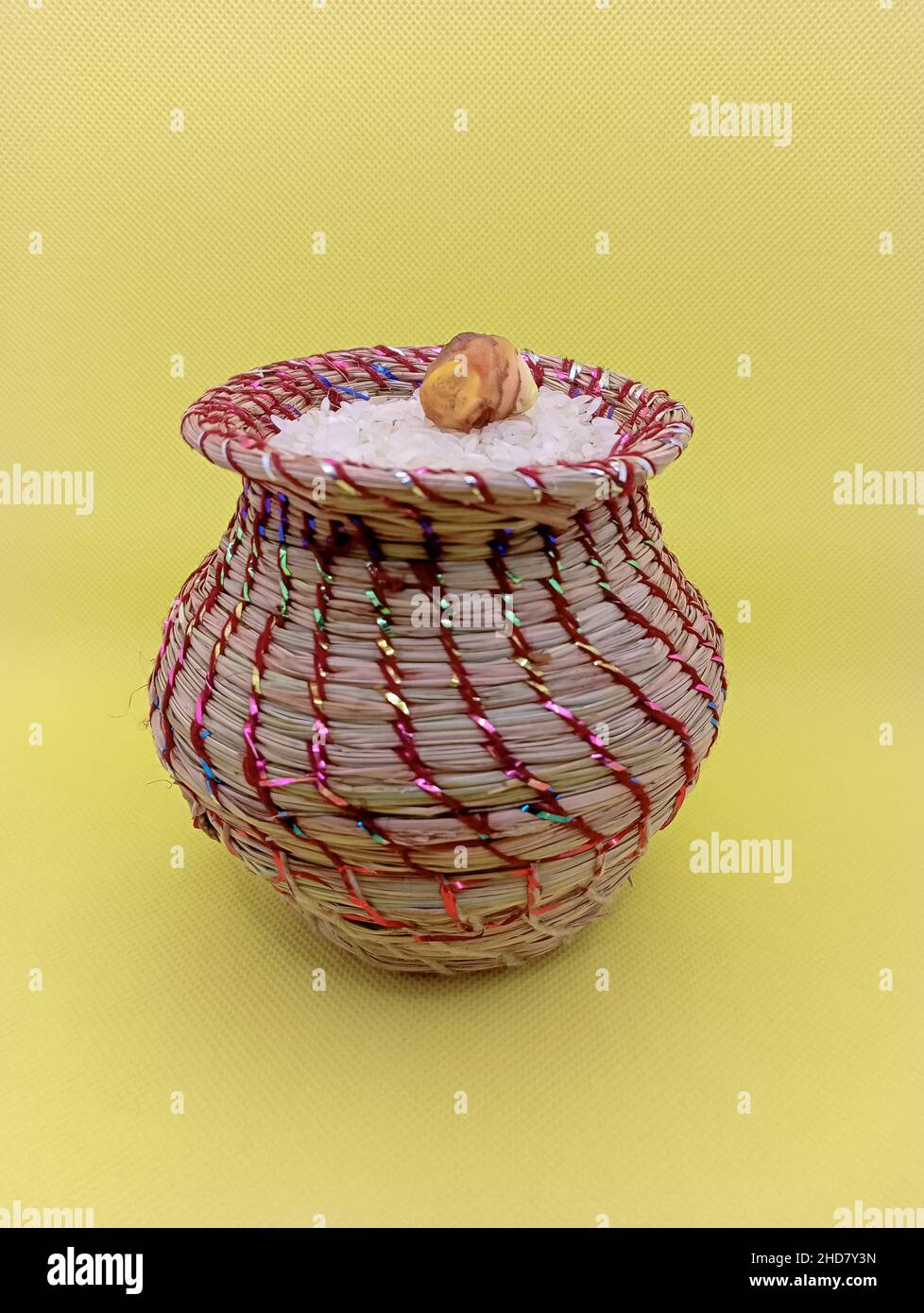 Kusha grass made pot with rice and ginger. Pot is made by hand and used in may worships. Stock Photo
