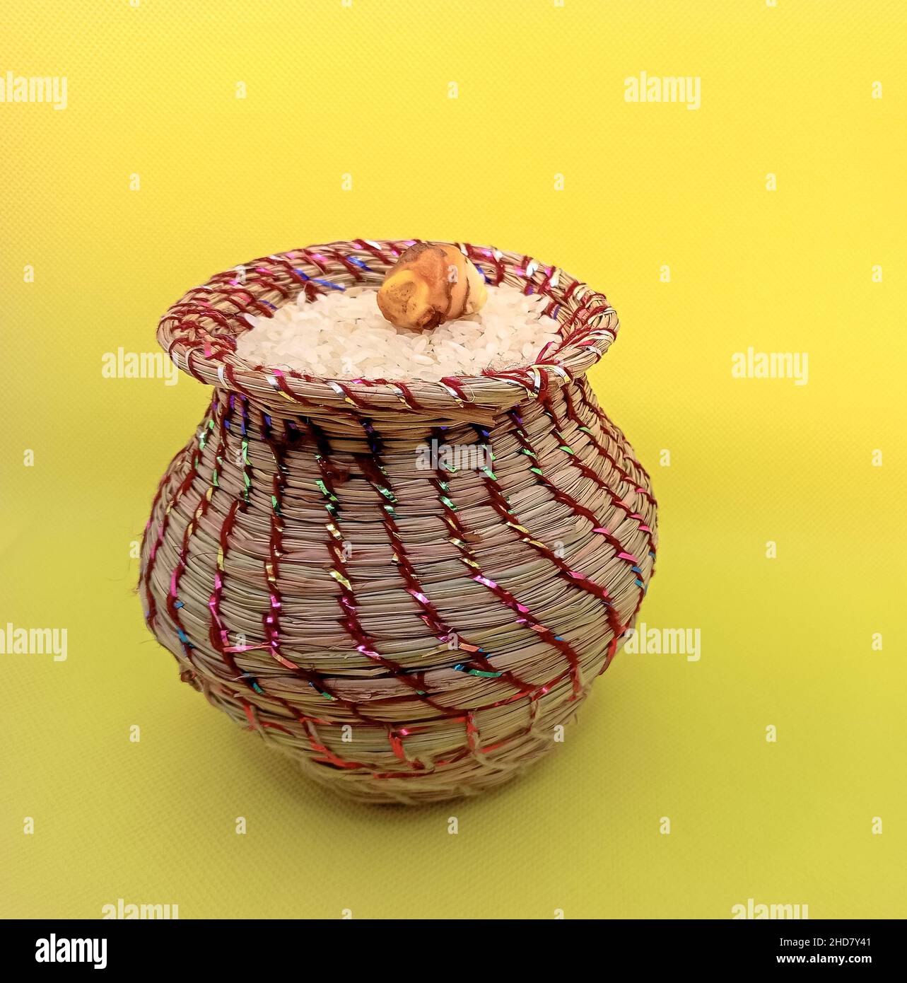 Kusha grass made pot with rice and ginger. Pot is made by hand and used in may worships. Stock Photo