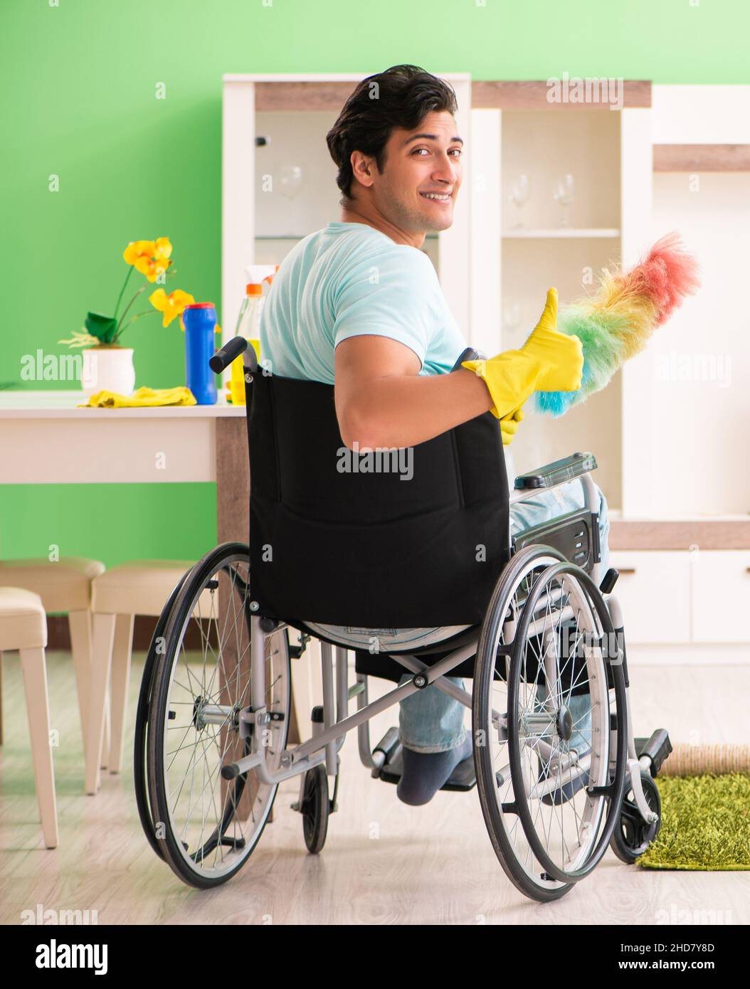 The disabled man on wheelchair cleaning house Stock Photo Alamy
