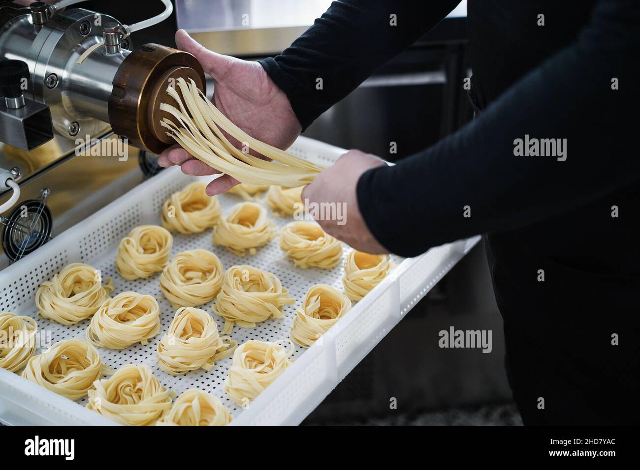 Man working with Pasta manufacture machine Stock Photo