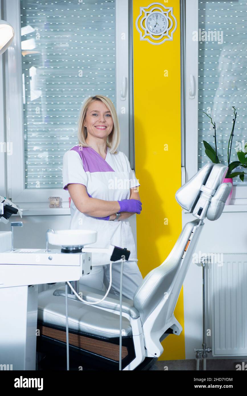 Professional female nurse standing in a dental clinic Stock Photo
