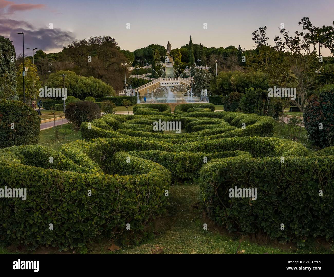 sinuously shaped hedges in the blue fountain park in the background Stock Photo