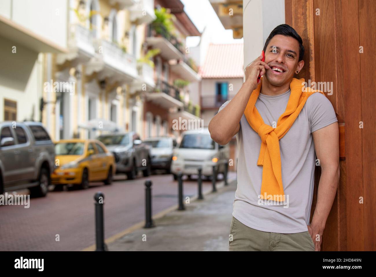 Young latino man in the city talking by mobile phone, Panama City, Central America Stock Photo