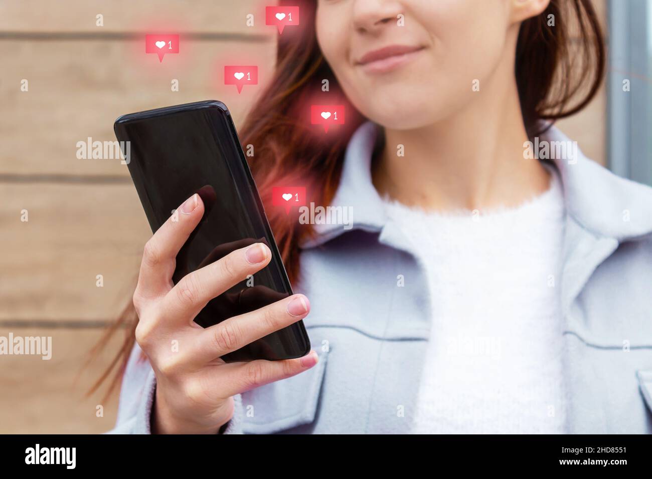 Likes from phone screen. Attractive young woman. Stock Photo