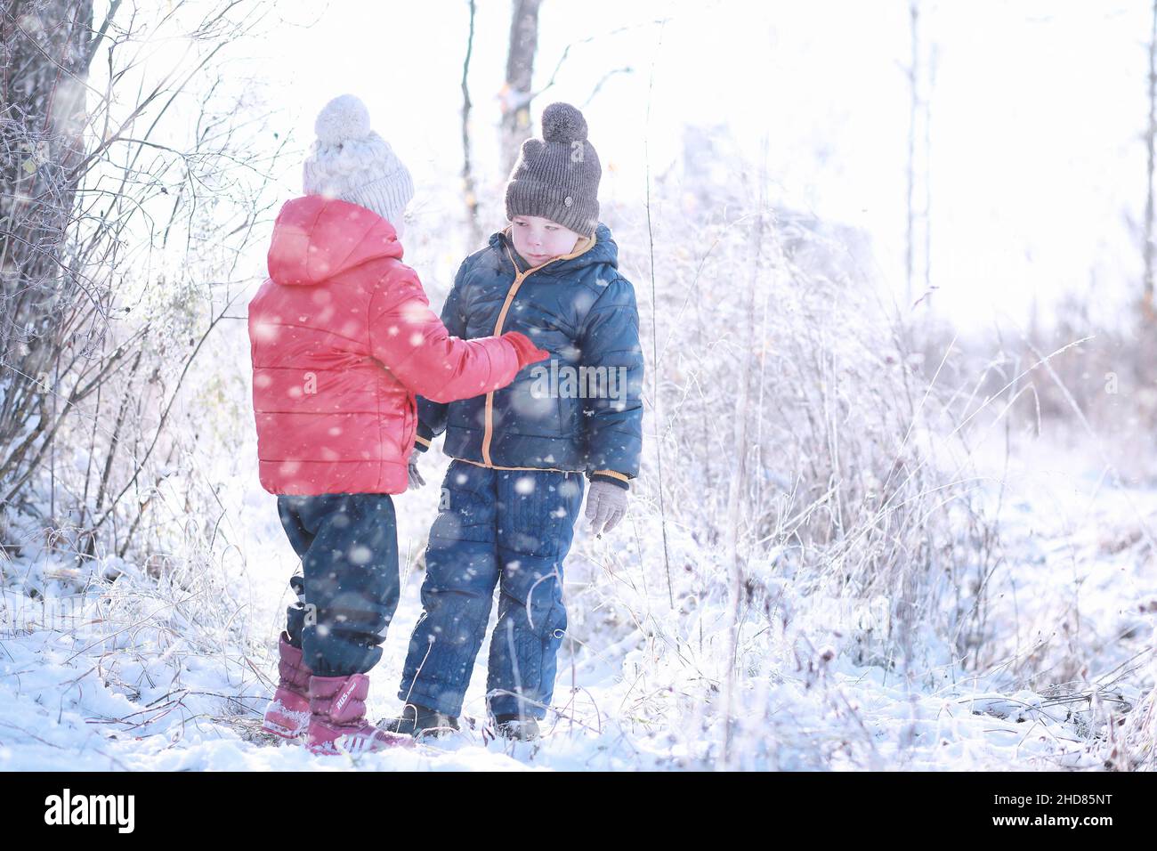 Kids walk in the park with first snow Stock Photo - Alamy
