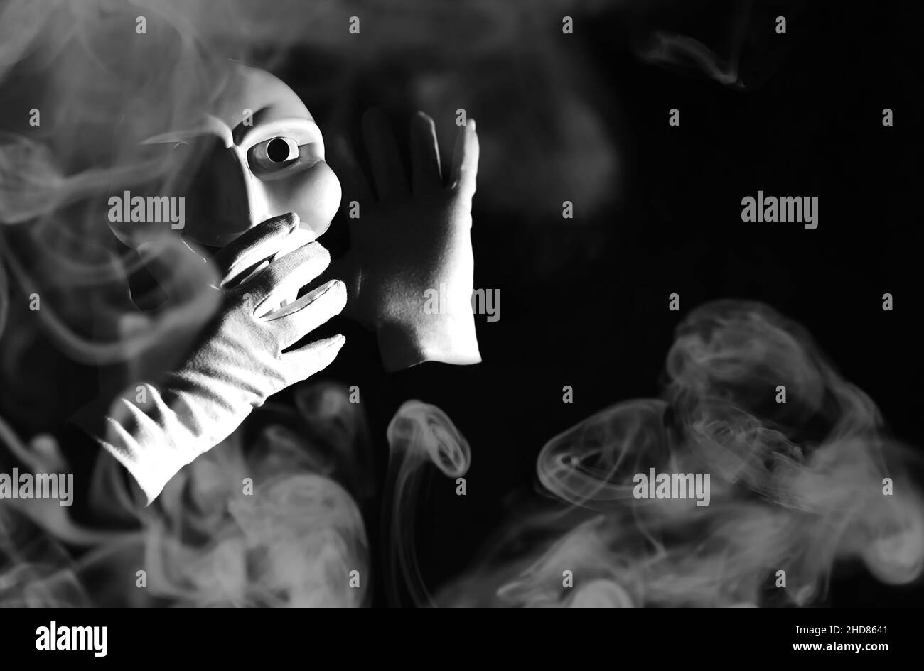 White Scary Mask On A Black Background With Whites Hands Stock Photo