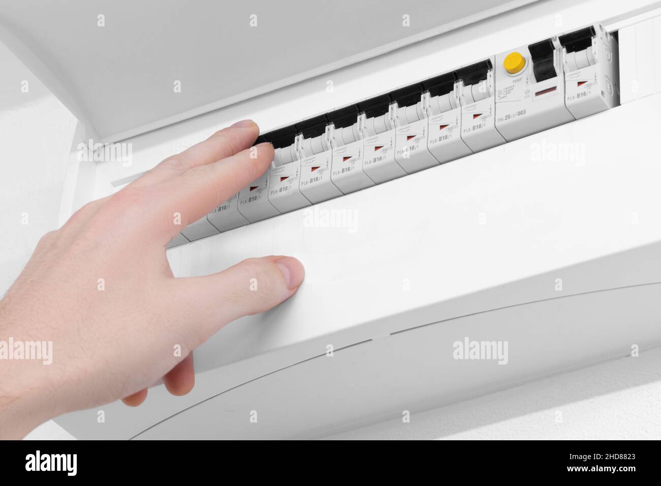 Detail of opened home white fuse box with set of black electric fuses