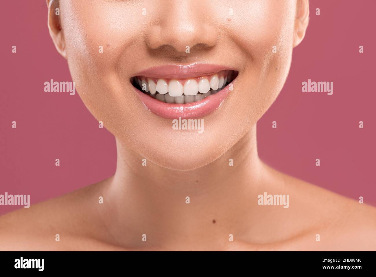 Female smile. Unrecognizable woman smiling, showing perfect white teeth Stock Photo