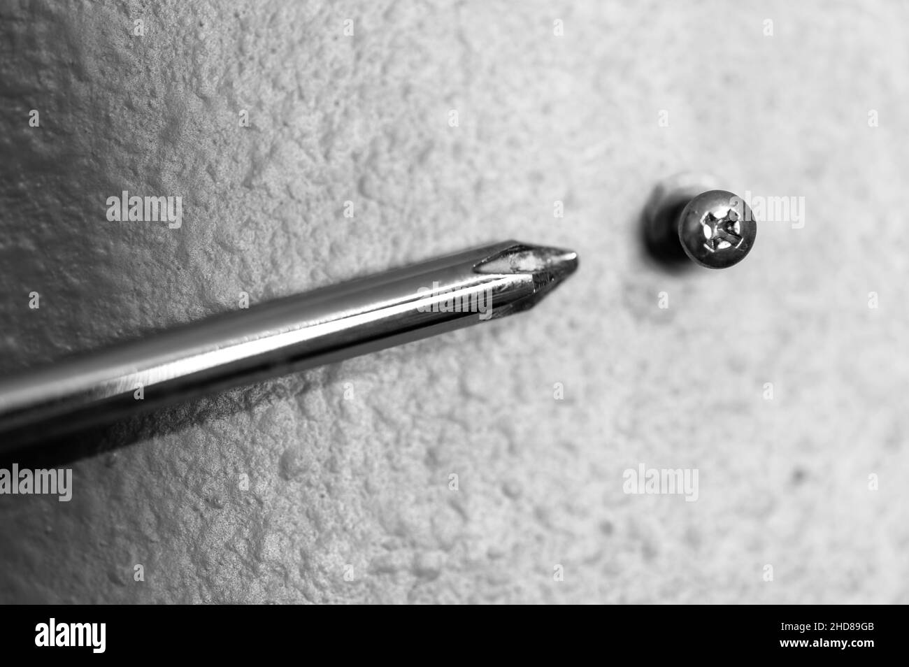 Selective focus on a typical drywall anchor installation with a Philips