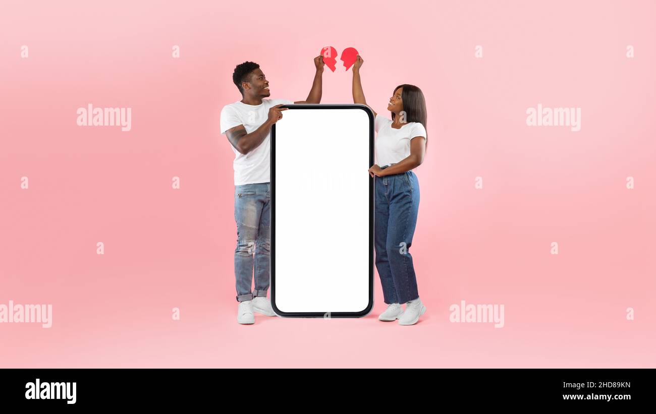 Black couple connecting two halves of broken heart, mockup screen Stock Photo