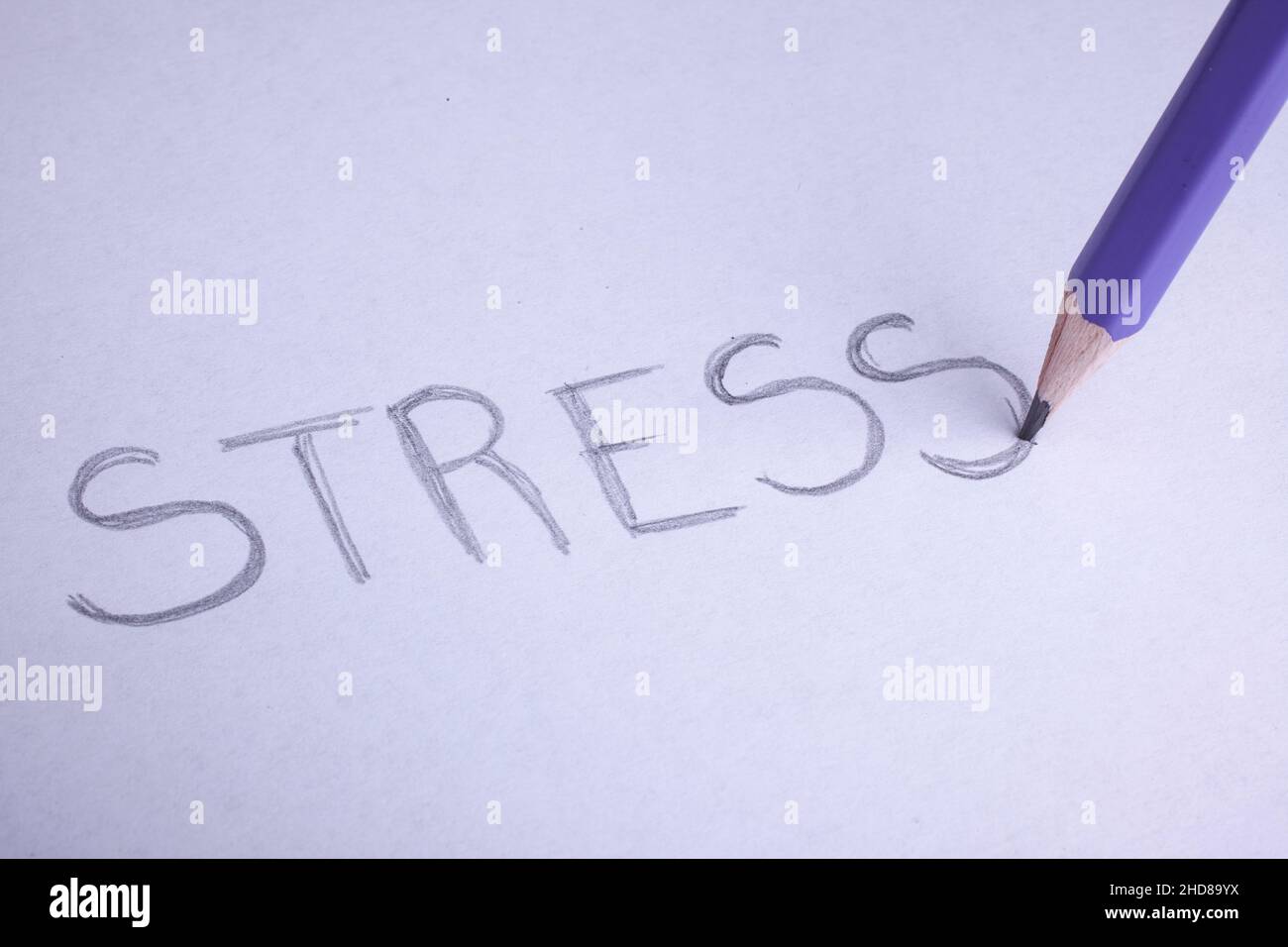 pastel pencil to write the word stress om white paper Stock Photo