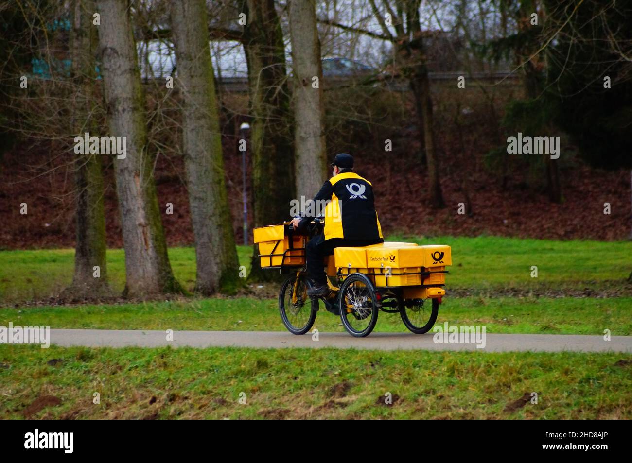 A postman delivers his freight. Stock Photo