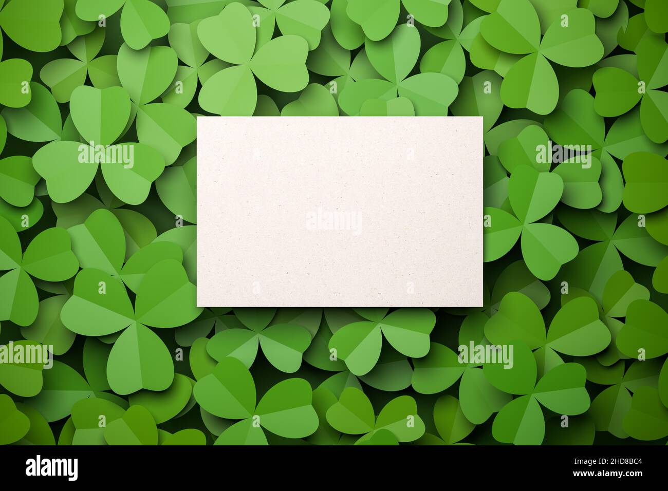 Cloverleaf background with an empty card for own text in the middle. Spring or St. Patrick's Day concept. Stock Photo