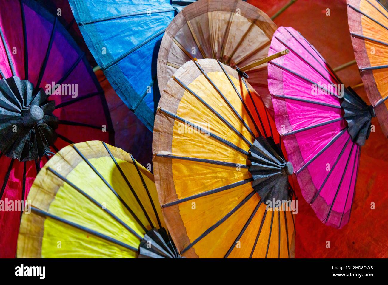 Colourful traditional paper umbrellas on display in a stall in the
