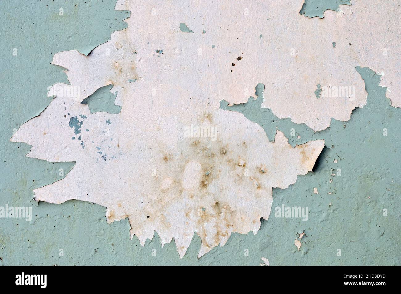 Paint peeling off concrete wall. Suitable as background or texture