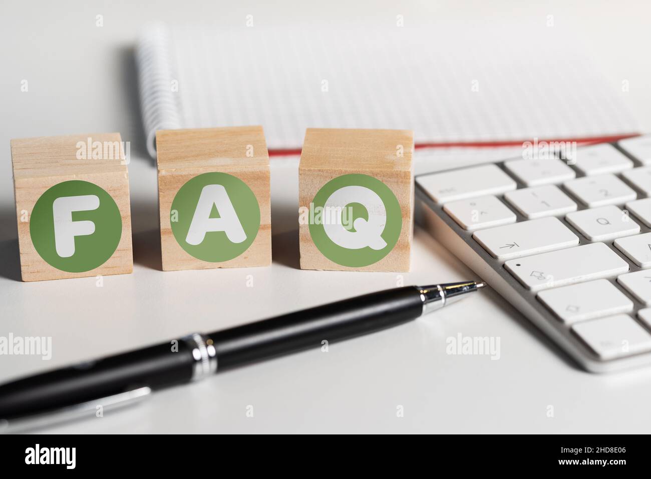 FAQ on wooden blocks on office desk with computer keyboard, frequently asked questions concept Stock Photo