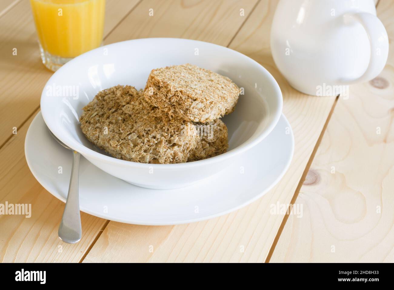 Healthy whole wheat breakfast cereal biscuits with orange juice Stock Photo