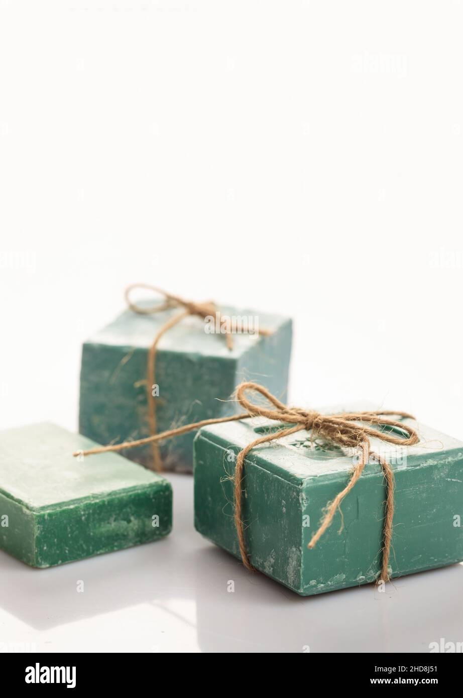 Handmade soap bars tied with rope on white background. Luxury green bath soap from olive aromatherapy, spa, refresh, healthcare, hygiene, herbal cosme Stock Photo