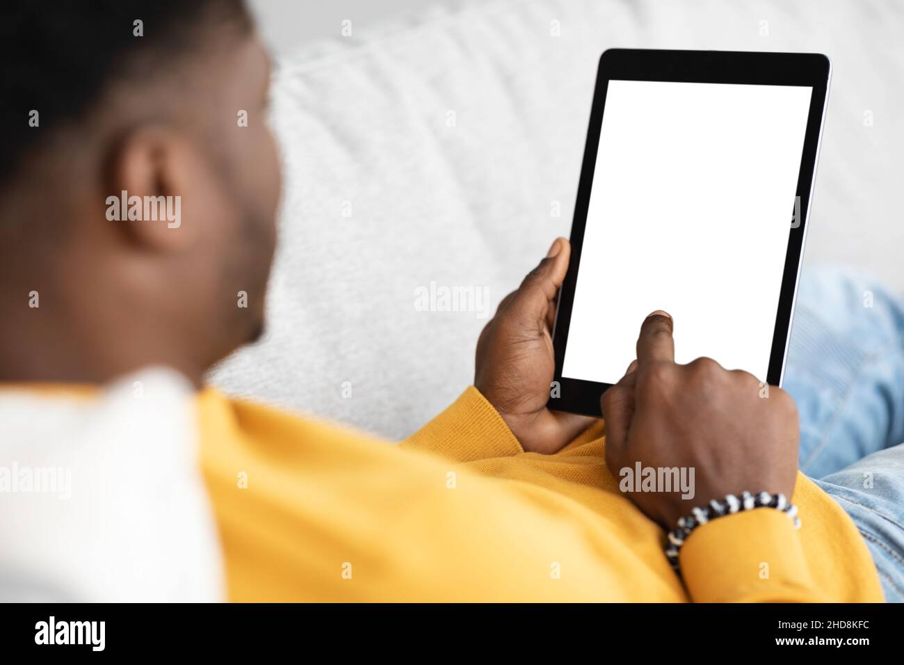 Modern digital tablet with blank screen in black guy hands Stock Photo