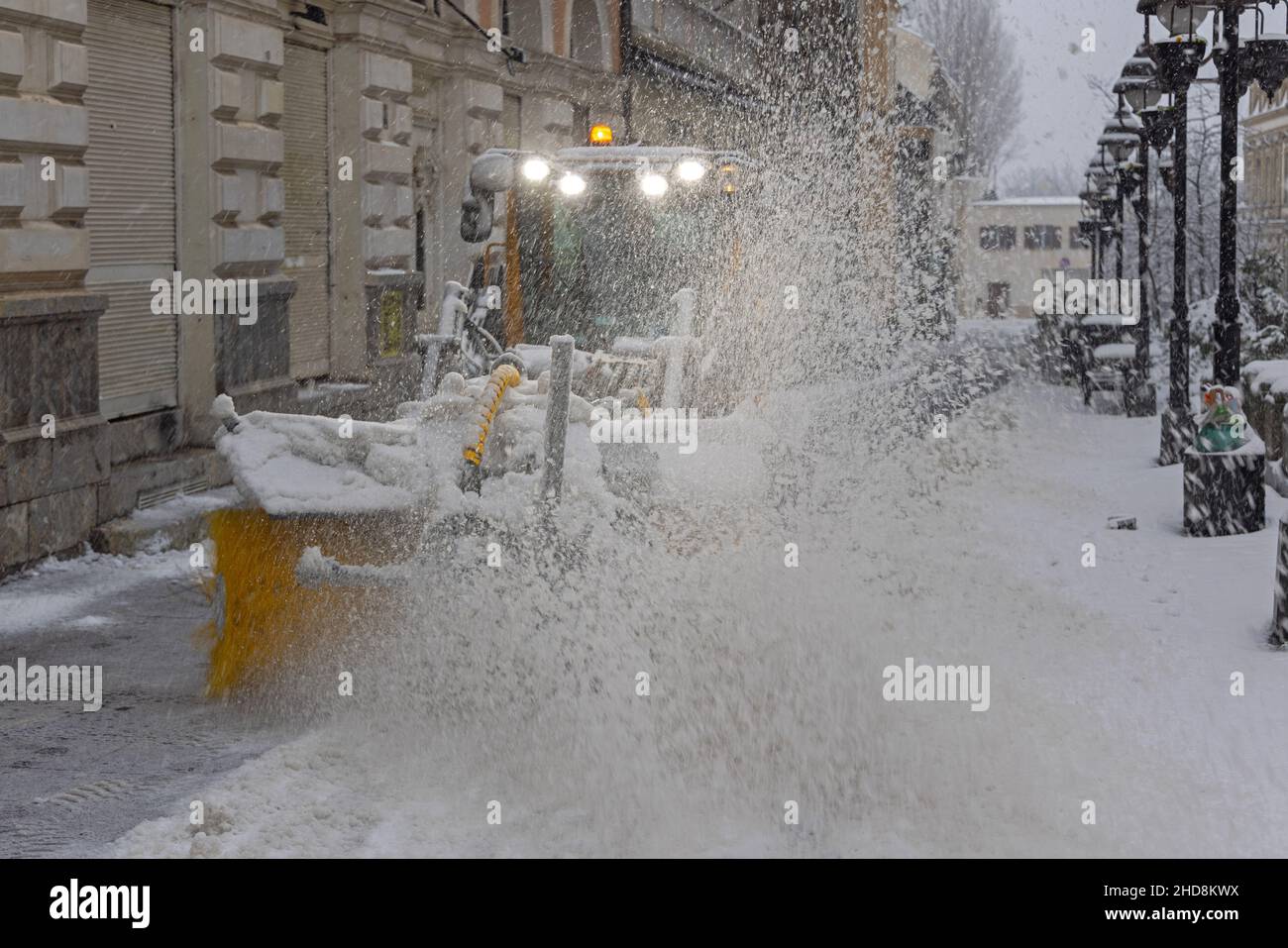 Snow Removal Power Brush Machinery at City Street Winter Stock Photo