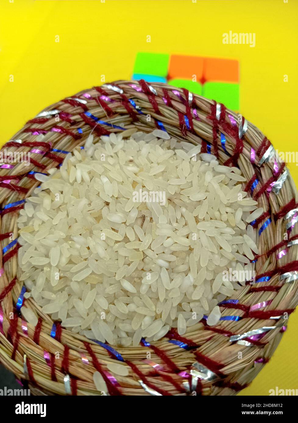 Kusha grass made pot with rice. Pot is made by hand and used in may worships. Stock Photo