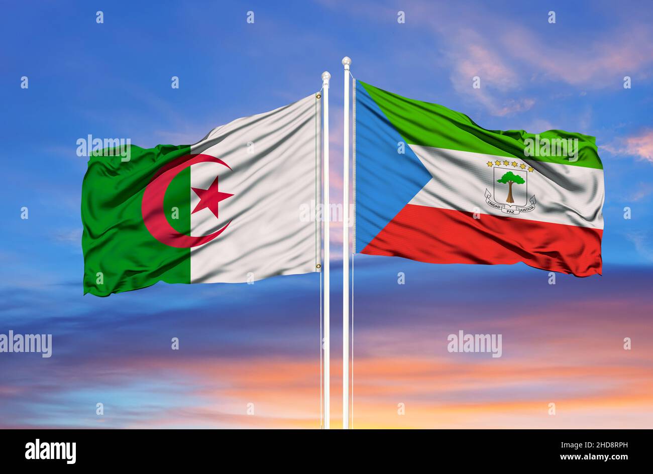 Algeria and Equatorial Guinea two flags on flagpoles and blue cloudy sky Stock Photo