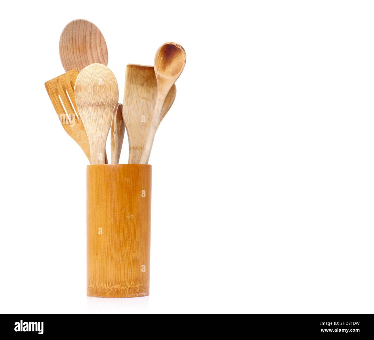 Assorted wooden spoons and spatulas on white with copy space Stock