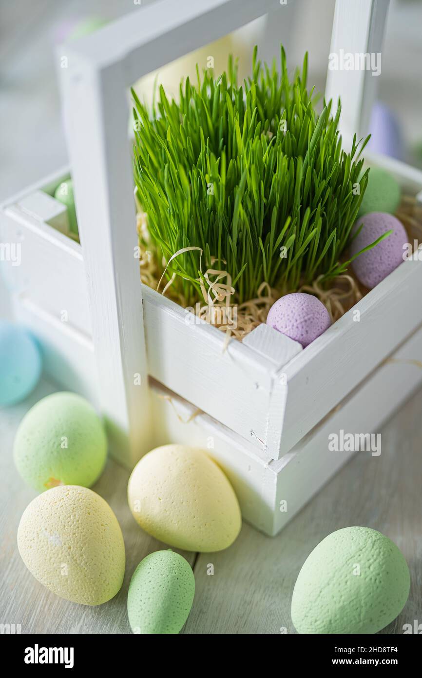 Flower composition with easter colorful dyed eggs in white wooden box. Easter composition. Stock Photo