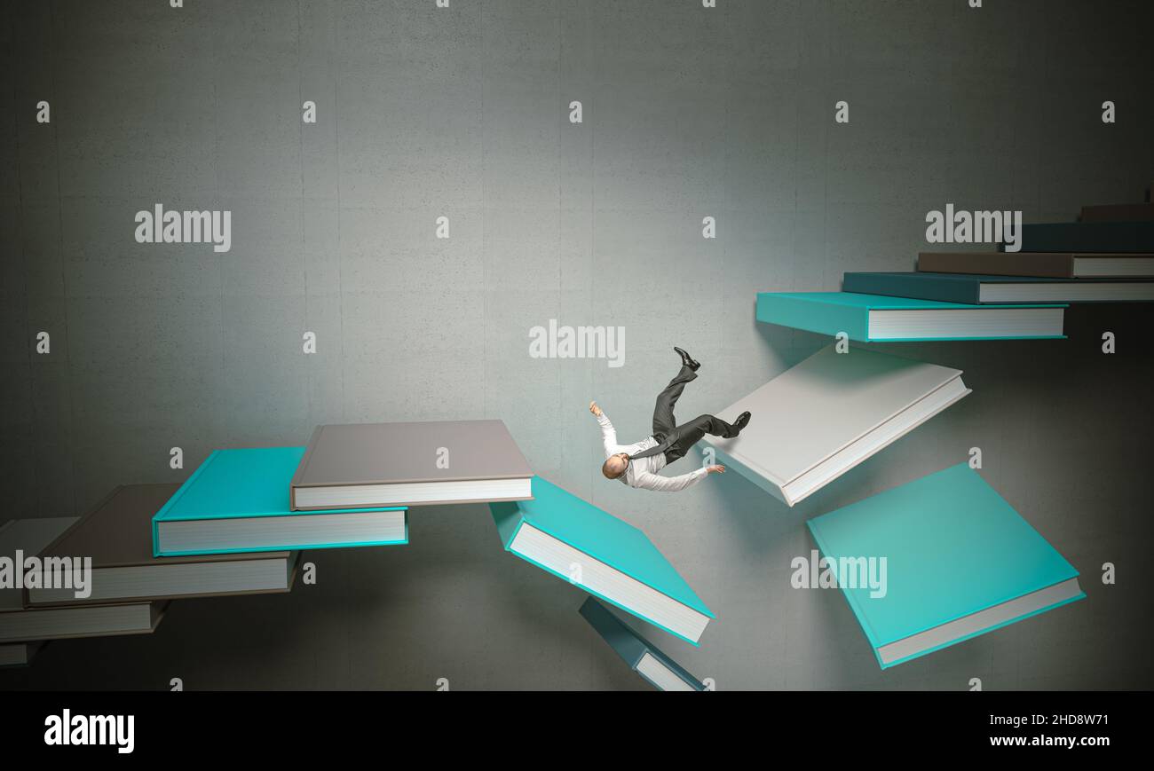 businessman falling from a ladder made of books. Stock Photo