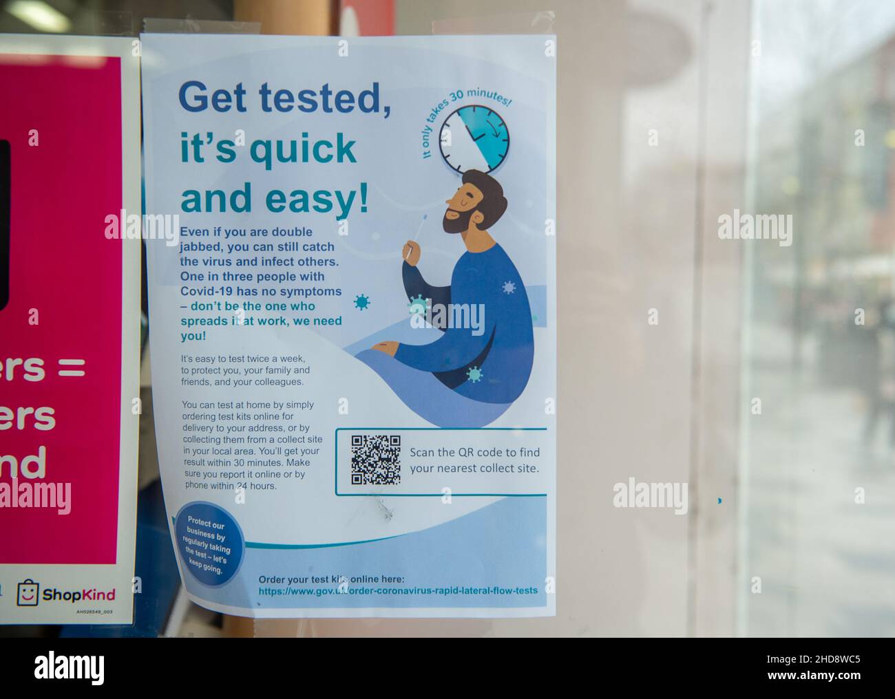 Slough, Berkshire, UK. 30th  December, 2021. A get tested sign in the window of WH Smith. Credit: Maureen McLean/Alamy Stock Photo