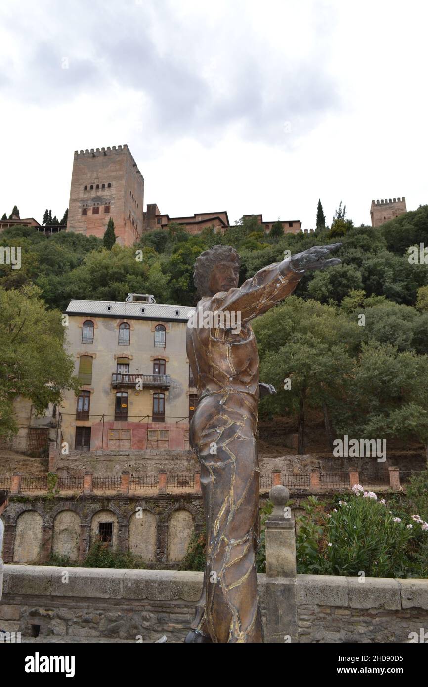 Bailaor sculpture in Paseo de los Tristes with the Alhambra and the Reuma hotel in the background Stock Photo
