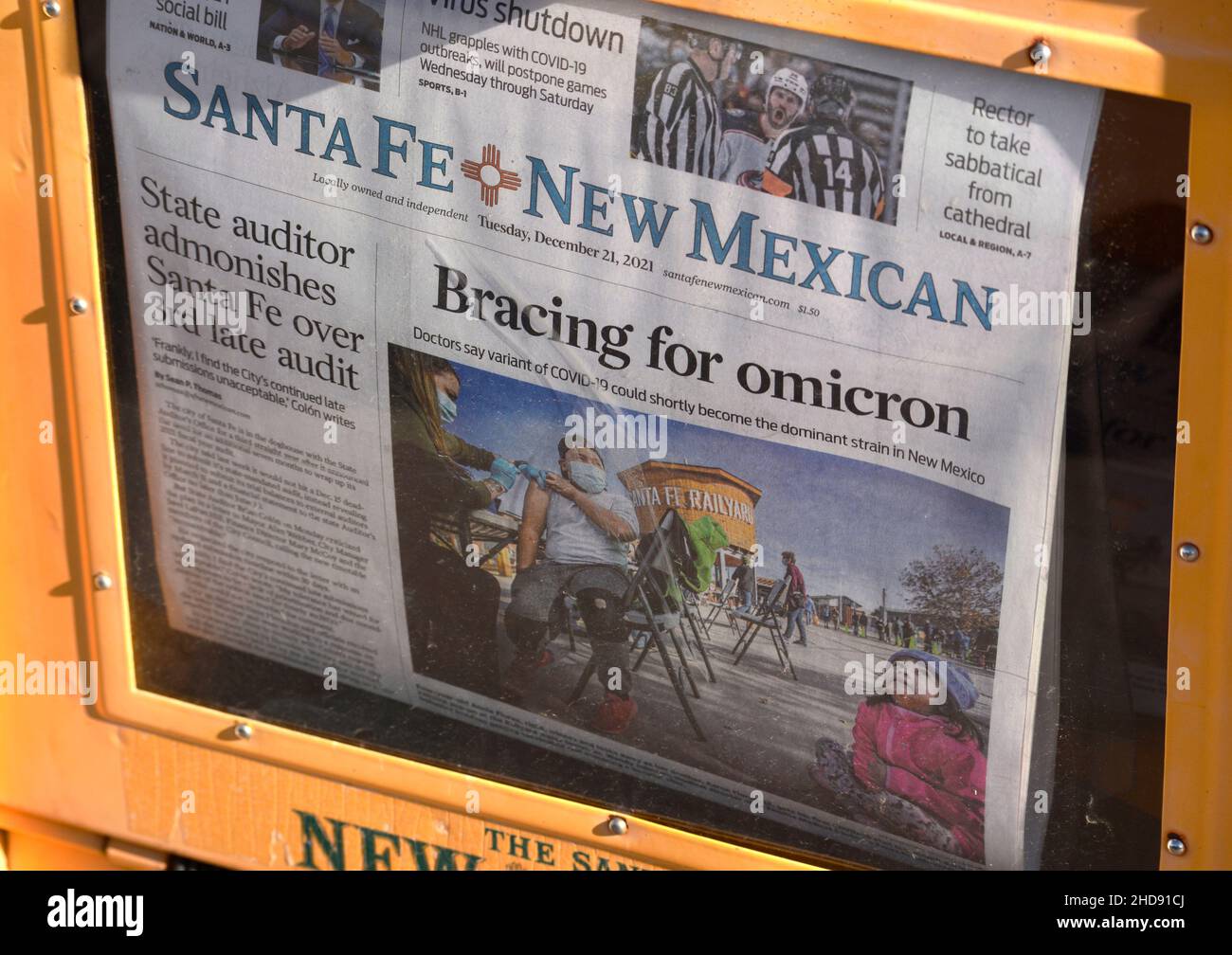 A coinoperated newspaper vending machine with a front page omicron headline in Santa Fe, New