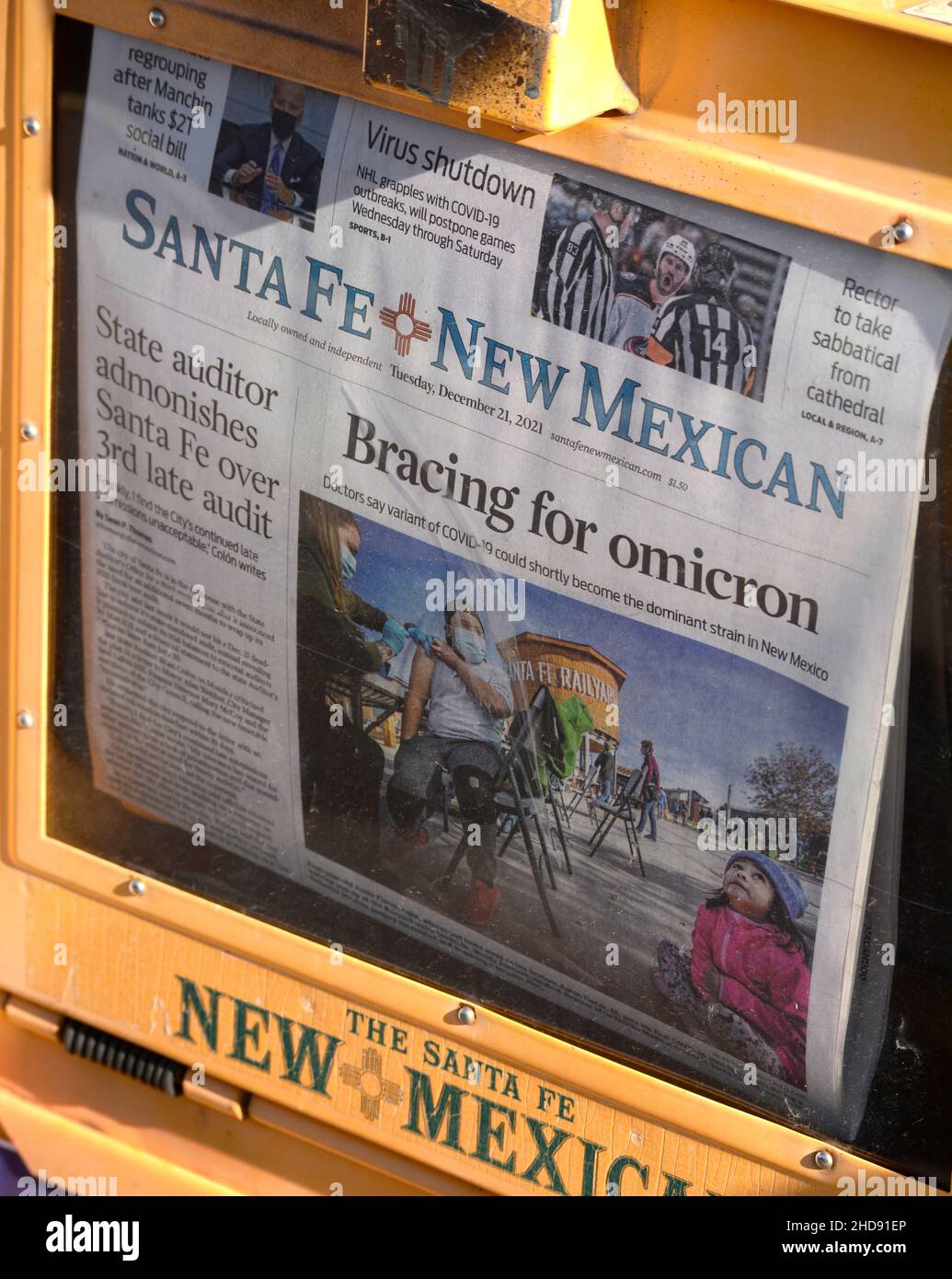 A coinoperated newspaper vending machine with a front page omicron headline in Santa Fe, New