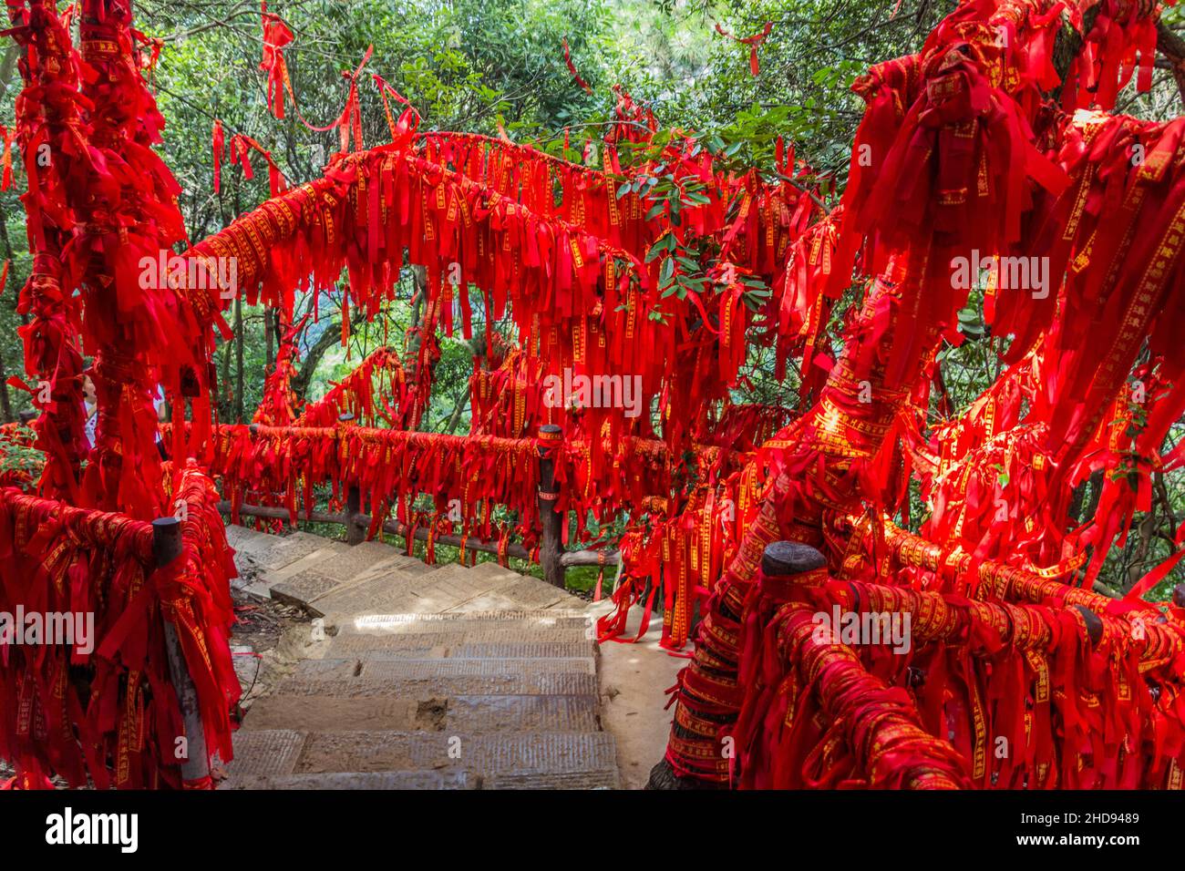Red blessing ribbons tied on railings and branches in Wulingyuan Scenic ...