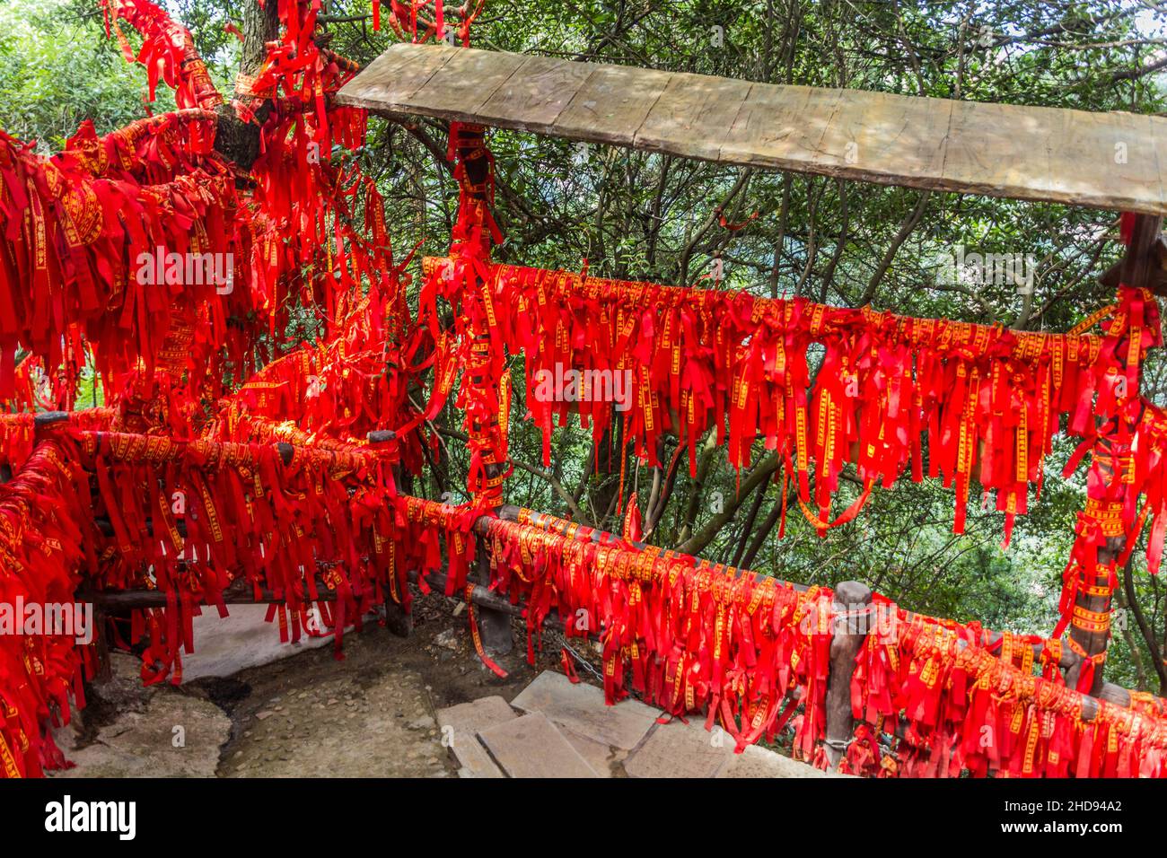 Red blessing ribbons tied on railings and branches in Wulingyuan Scenic ...
