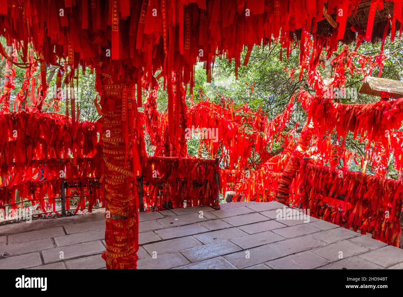 Red blessing ribbons tied on railings and branches in Wulingyuan Scenic ...