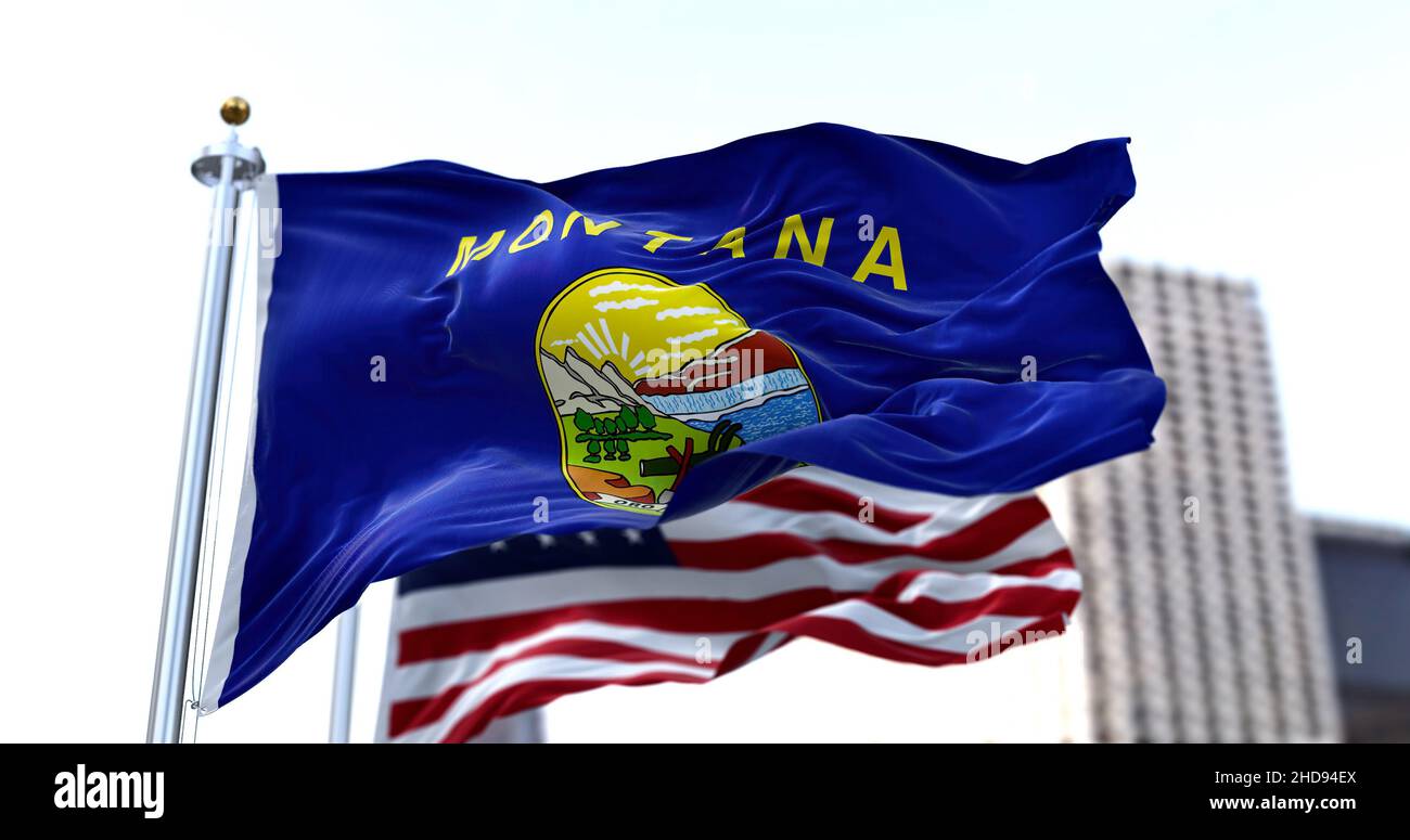 the flag of the US state of Missouri waving in the wind with the American flag blurred in the background. Montana was admitted to the Union on Novembe Stock Photo