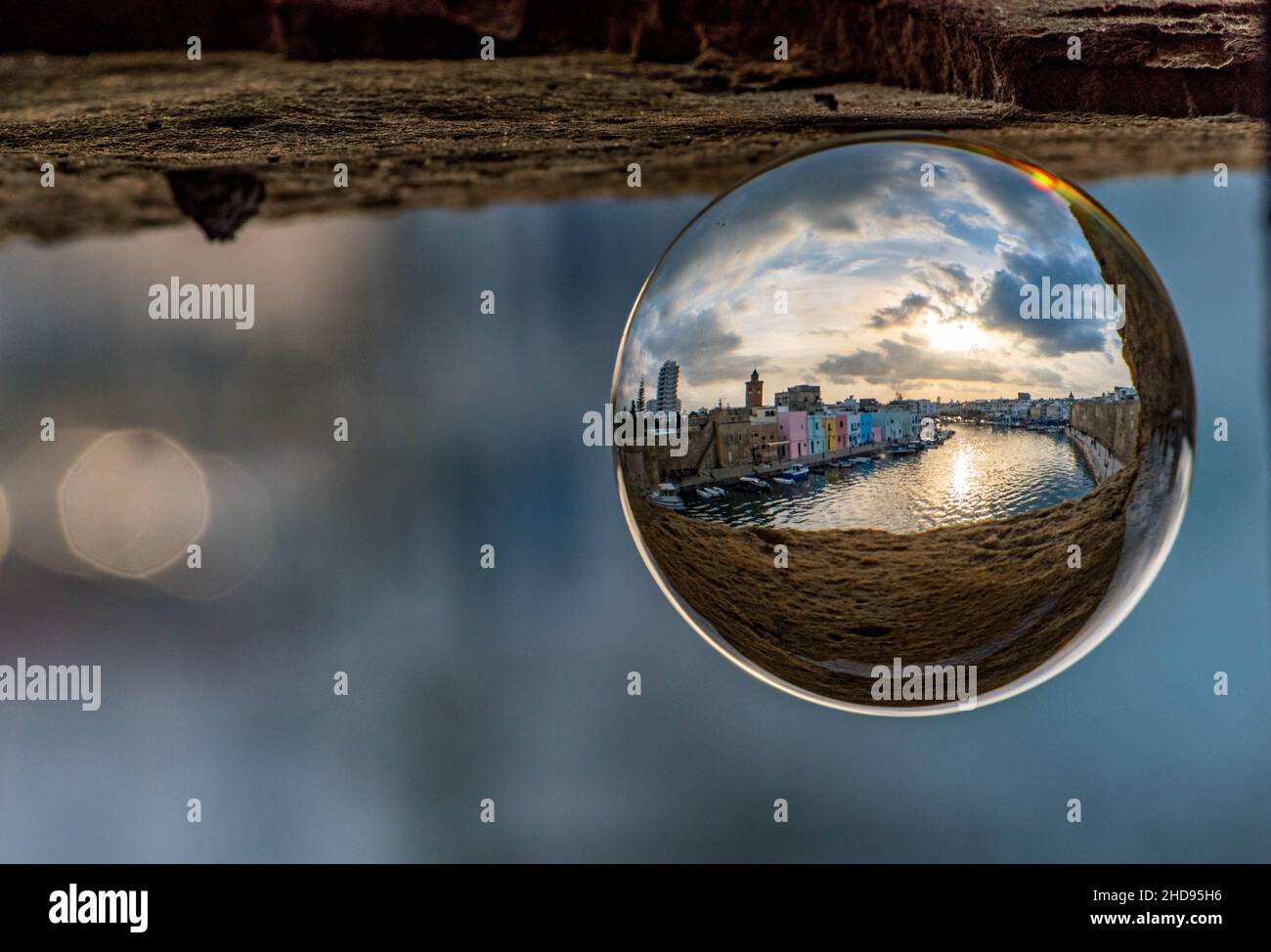 Selective focus shot of a small ball with reflection of Bizerte in Tunisia inside Stock Photo