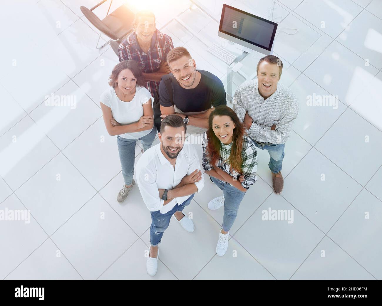 young professionals standing near the desktop Stock Photo - Alamy