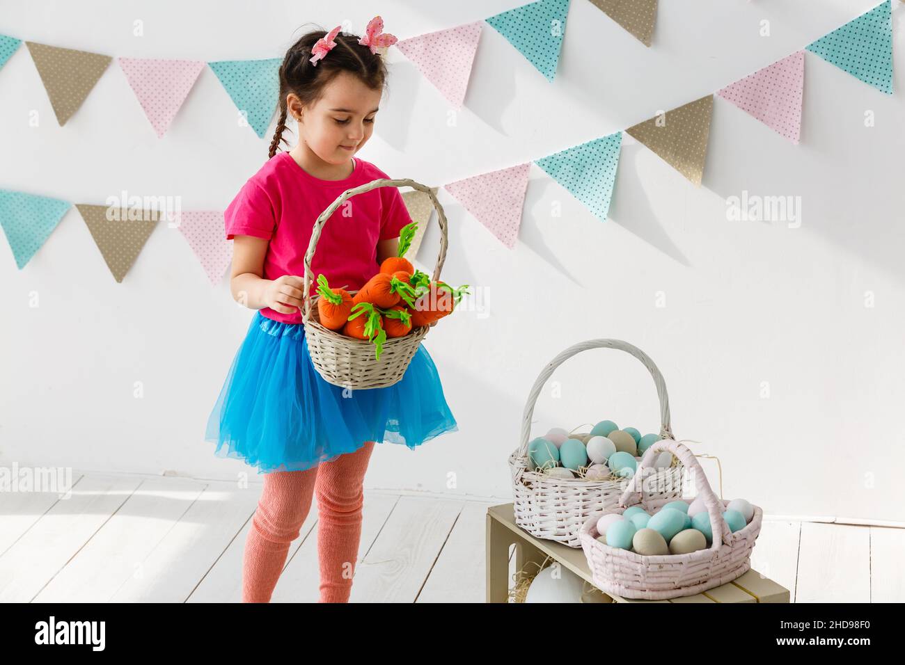 Cute little girl with bunny ears and basket of Easter eggs Stock Photo ...