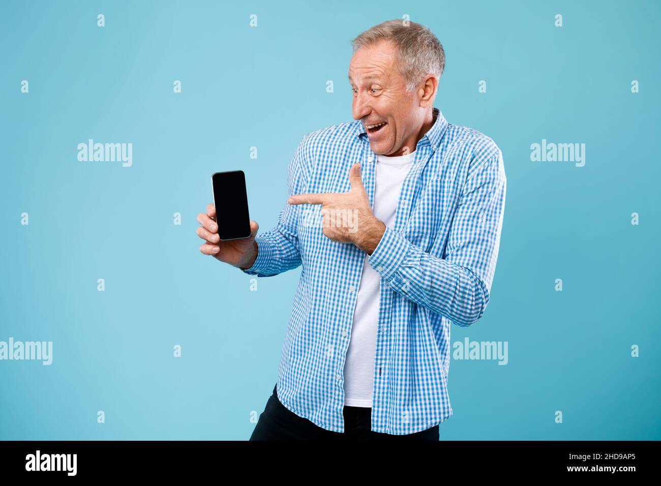 Mature man pointing finger at empty smartphone screen Stock Photo