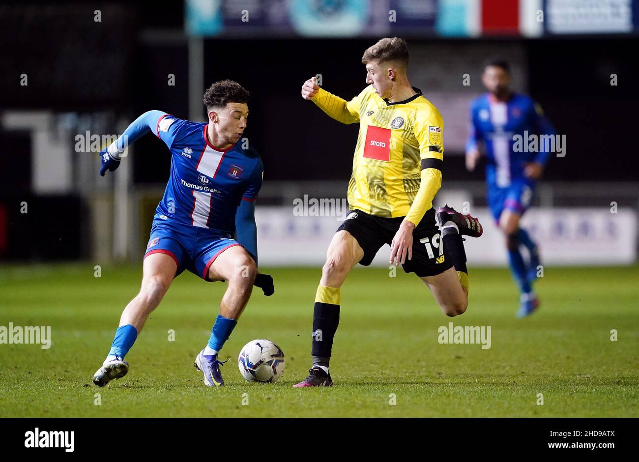 Harrogate Town's Joshua Austerfield and Carlisle United's Jordan Gibson (left) during the Papa John's Trophy round of sixteen match at the EnviroVent Stadium, Harrogate. Picture date: Tuesday January 4, 2022. Stock Photo