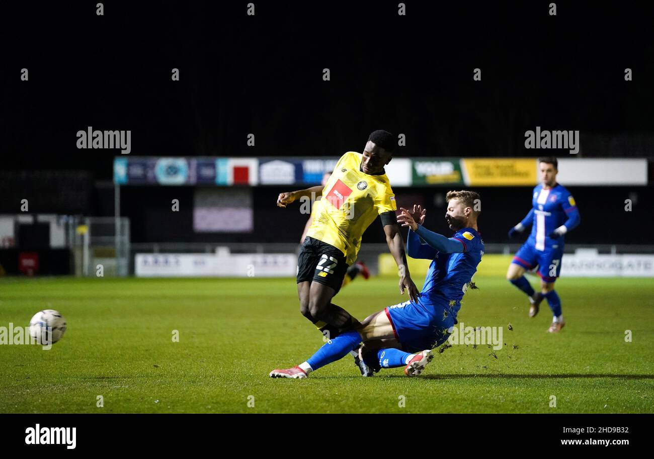 Harrogate Town's Brahima Diarra is tackled by Carlisle United's Jack Armer during the Papa John's Trophy round of sixteen match at the EnviroVent Stadium, Harrogate. Picture date: Tuesday January 4, 2022. Stock Photo