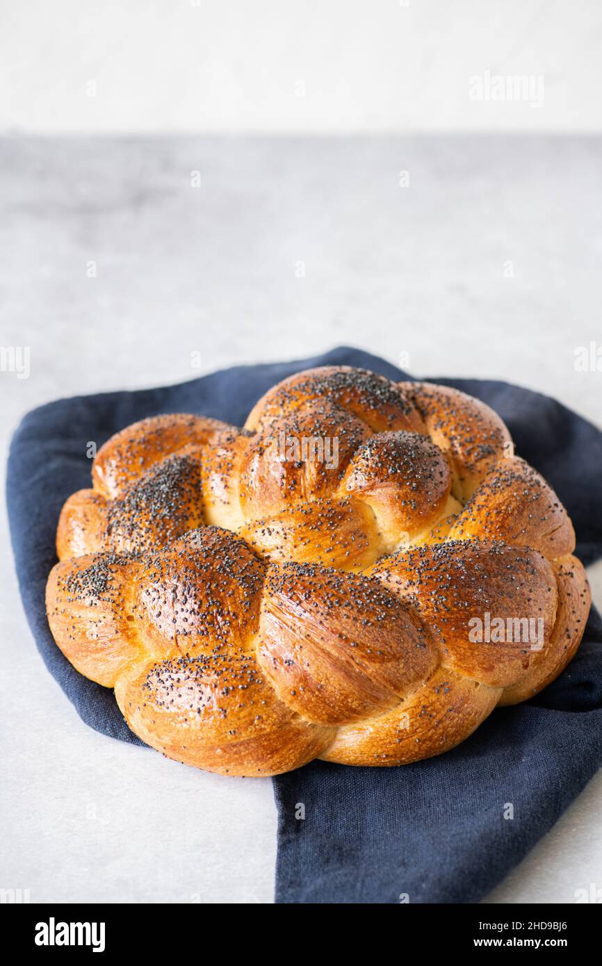 Homemade round challah with poppy seeds. Traditional freshly baked