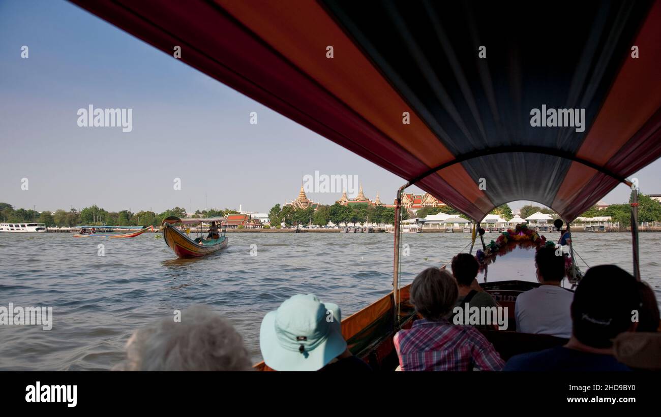 Bangkok, Thailand - April 4, 2011: Tourists and a view from a long boat on the Chao Phraya River Stock Photo