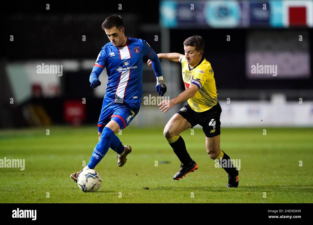 Harrogate Town's Joshua Falkingham (right) and Carlisle United's Joe Riley during the Papa John's Trophy round of sixteen match at the EnviroVent Stadium, Harrogate. Picture date: Tuesday January 4, 2022. Stock Photo