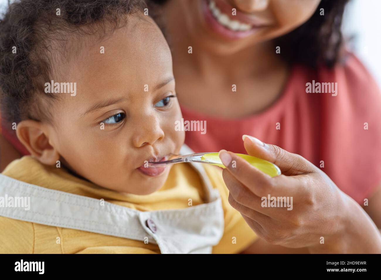 https://c8.alamy.com/comp/2HD9EWR/baby-feeding-closeup-of-cute-little-black-infant-boy-eating-from-spoon-2HD9EWR.jpg